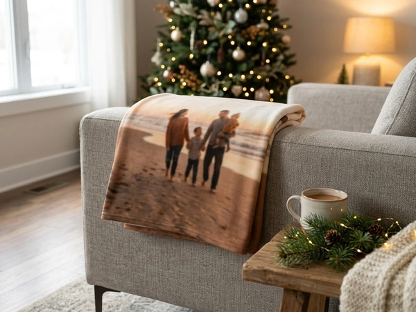 Fleece Christmas blanket at sofa size folded over the arm of a couch