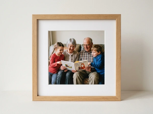 Oak framed picture of grandparents reading a book with two grandchildren