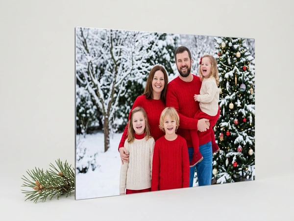 Metal print of a family of six in red sweaters in front of a snowy Christmas tree