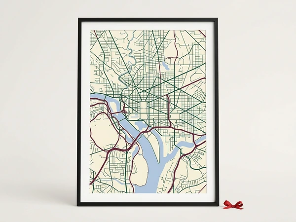 Black framed city map poster of green streets and a winding blue river on cream