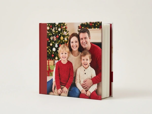 Photo book cover of a man, a woman and two boys in sweaters posing by a Christmas tree