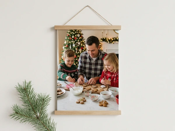 Wood canvas wall hanging of a man and two children decorating gingerbread cookies at a table