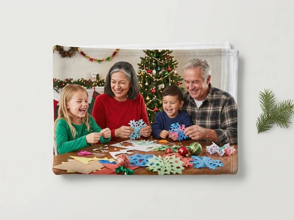 Fleece blanket of grandparents cutting paper snowflakes with a girl and a boy