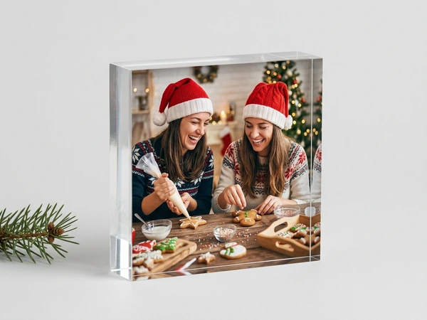 MixBlox of two women in Santa hats decorating cookies at a kitchen table