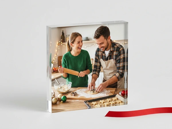 Acrylic print of a man and a woman rolling out cookie dough in a festive kitchen