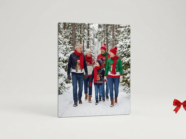 Metal print of an older couple, two adults and a child walking a snowy forest path