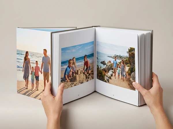 Thick family photo album open on beach photos