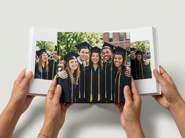 Graduation photo book open on a group photo of graduates