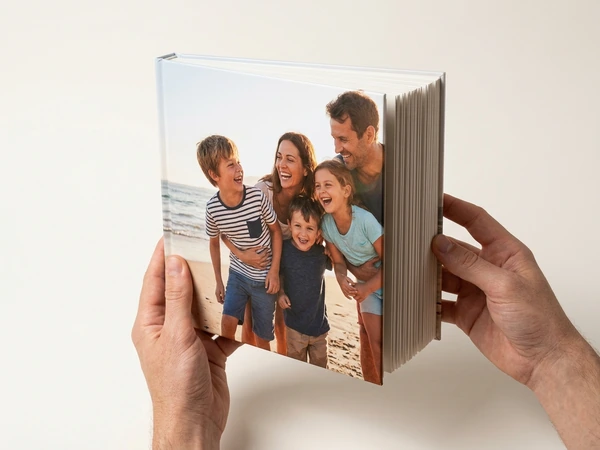 Hardcover photo book standing upright with a family photo on the cover