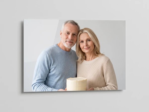 Acrylic print of a gray-haired man and a blonde woman holding a small white cake