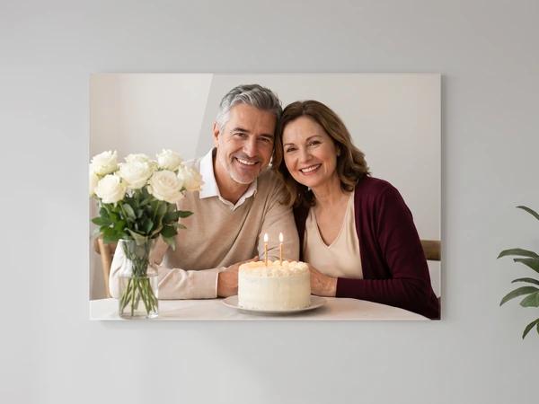 Acrylic print of a couple seated at a table with a vase of white roses and a candlelit cake