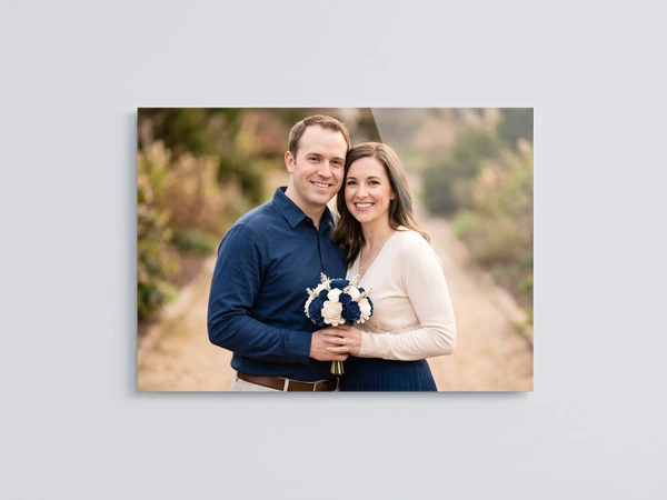 Acrylic print of a couple on a trail, the woman holding a bouquet of white and navy flowers