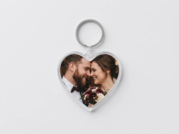 Heart keychain with a close photo of a bearded groom and a bride touching heads