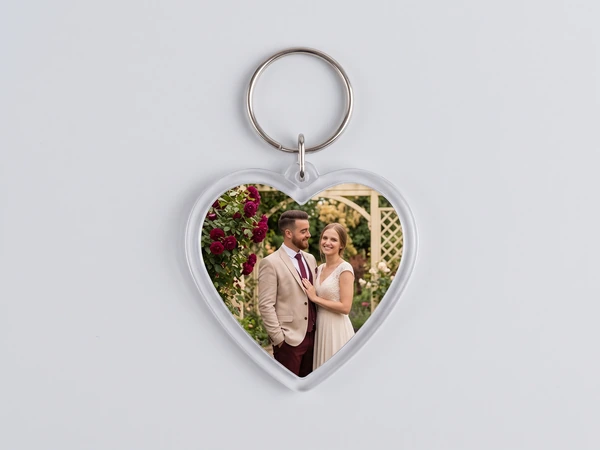 Heart keychain with a photo of a couple standing under a rose arbor
