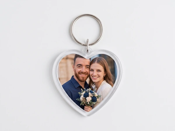 Heart keychain with a photo of a couple, the woman holding a navy and white bouquet