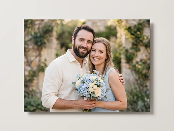 Metal print of a couple in a garden, the woman holding a blue and white bouquet