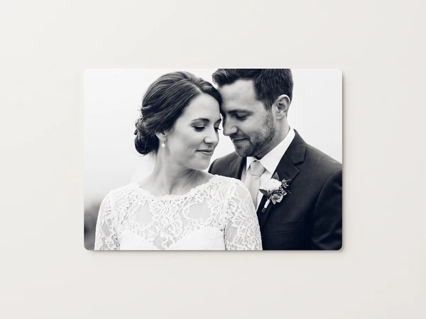 Black and white metal print of a bride and groom with their heads together
