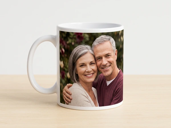 Photo mug printed with an older couple cheek to cheek in front of red roses