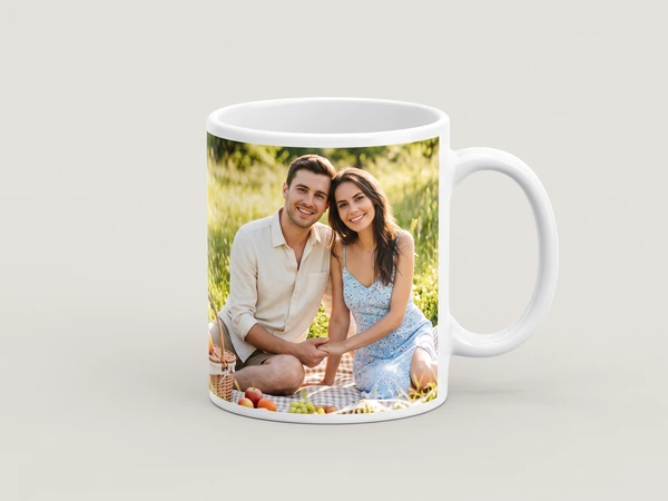 Photo mug printed with a couple sitting on a picnic blanket in a meadow