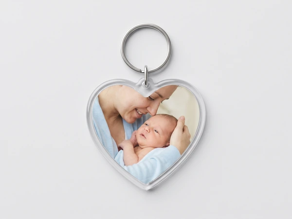 Heart keychain with a photo of a mother kissing a newborn on the head