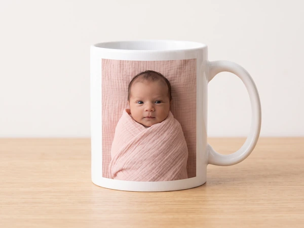 Photo mug printed with a newborn swaddled in pink