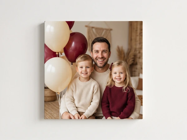 Canvas print of a father and two children in front of burgundy and cream balloons