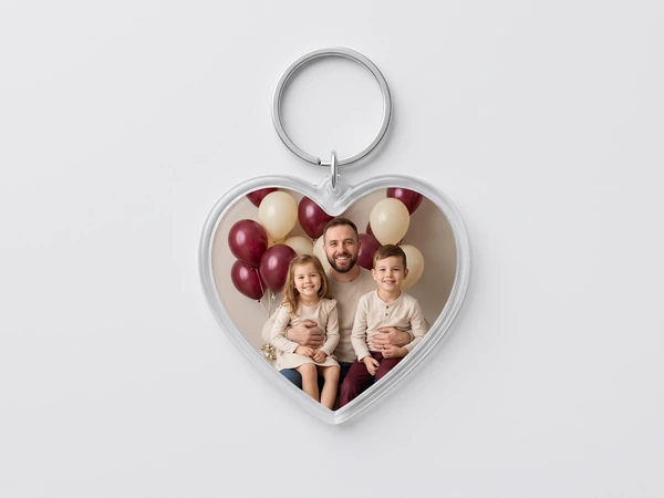Heart keychain with a photo of a father and two children in front of balloons