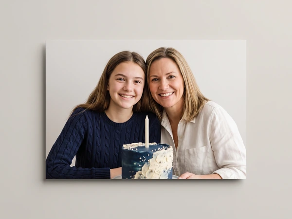 Metal print of a teenage girl and her mother with a navy birthday cake