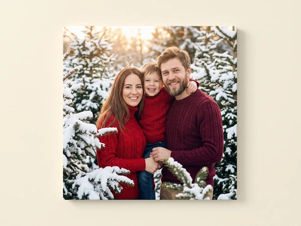 Canvas print of a family of three in red sweaters among snow-covered pine trees