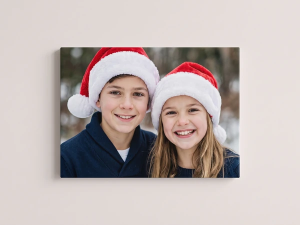 Canvas print of a brother and sister in Santa hats