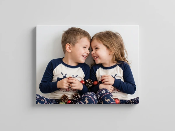 Canvas print of two children in matching reindeer pajamas