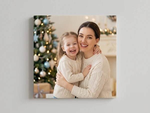 Portrait canvas print of a mother hugging her daughter in front of a Christmas tree