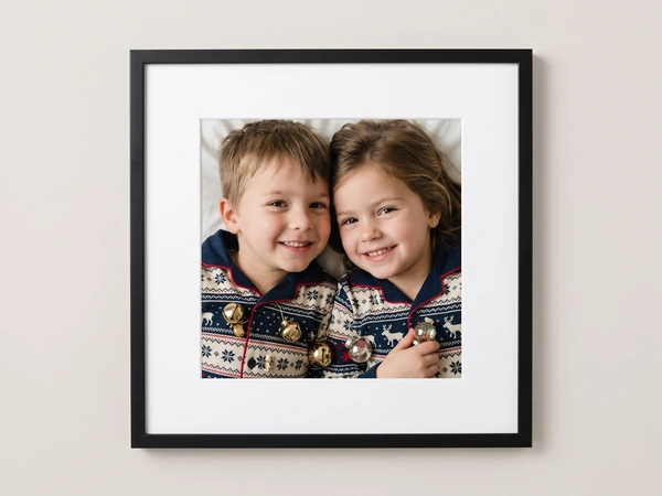 Black framed print of a brother and sister in Fair Isle sweaters