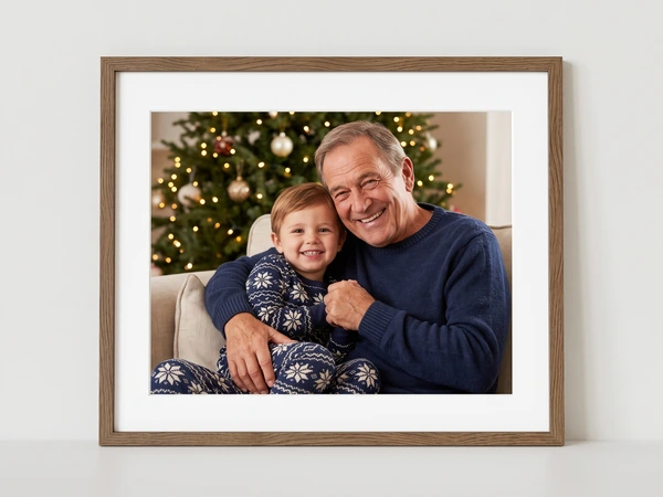 Walnut framed print of a grandfather hugging a grandson by a Christmas tree