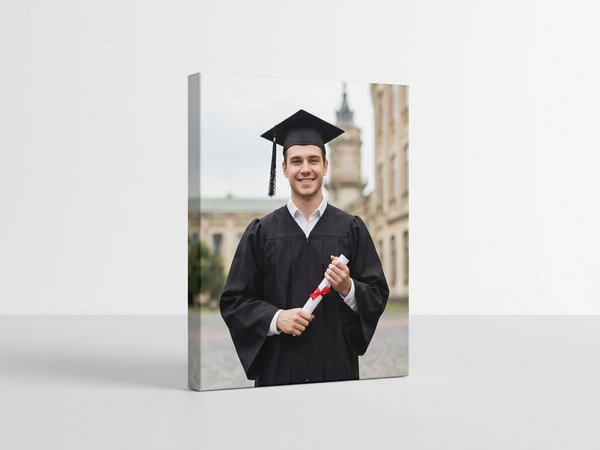 Portrait canvas print of a male graduate holding a diploma with a red ribbon