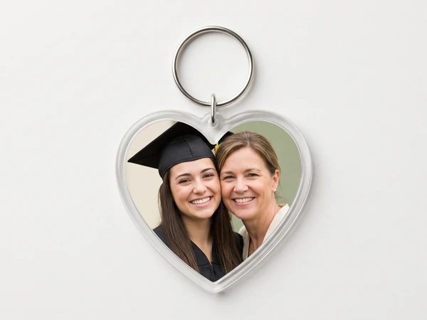 Heart keychain with a photo of a graduate in a black cap with her mother