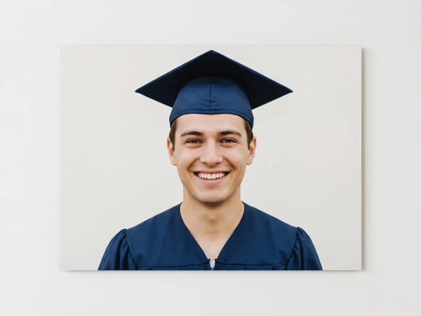Metal print of a young man in a navy graduation cap against a plain background