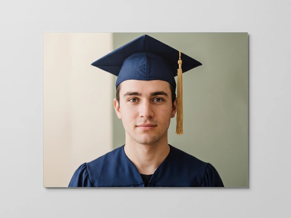 Metal print of a serious graduate in a navy cap with a gold tassel