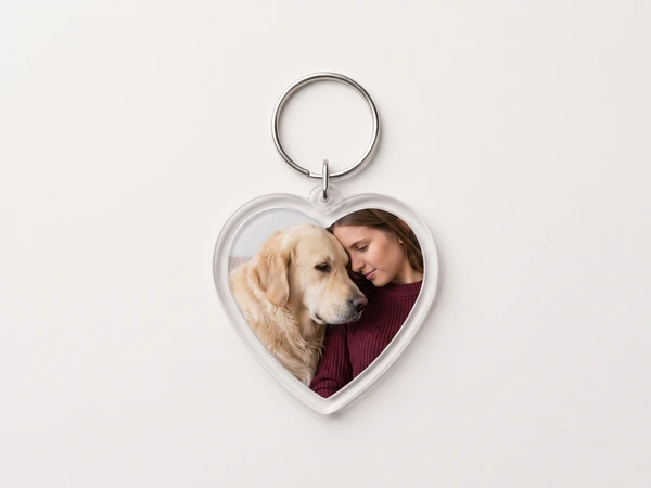 Heart keychain with a photo of a woman cuddling a golden retriever