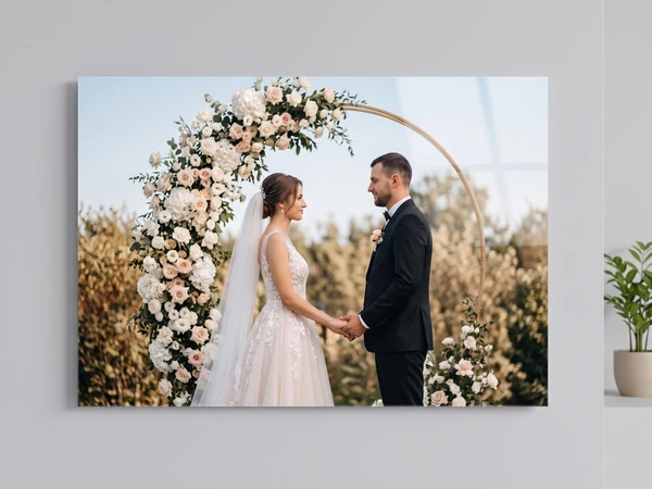 Acrylic print of a couple holding hands under a floral arch