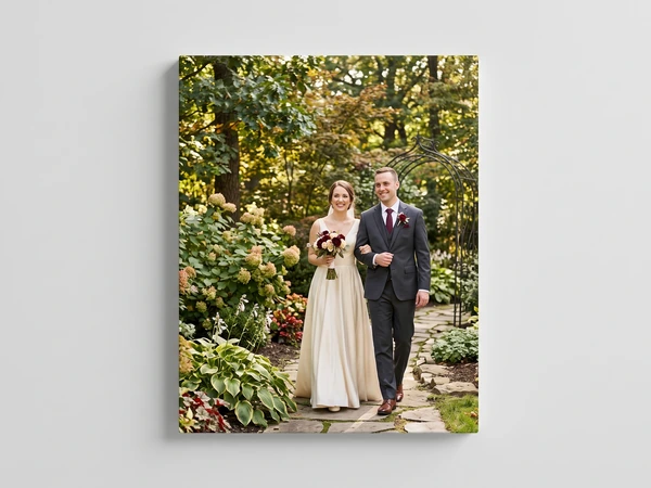Portrait canvas print of a newly married couple walking a stone path through a wooded garden