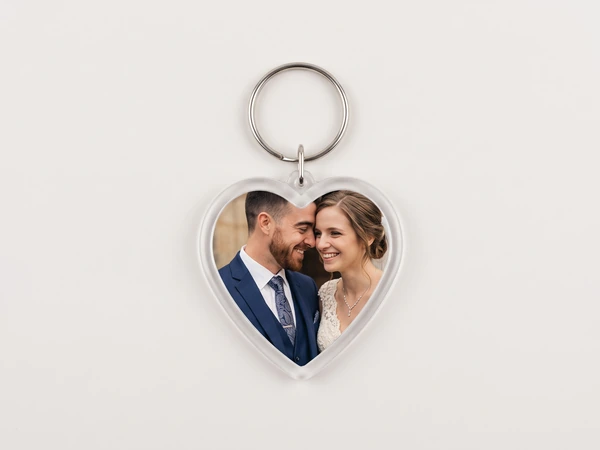 Heart keychain with a photo of a groom and bride smiling forehead to forehead