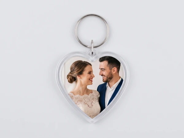Heart keychain with a photo of a bride in lace and a groom in navy smiling at each other