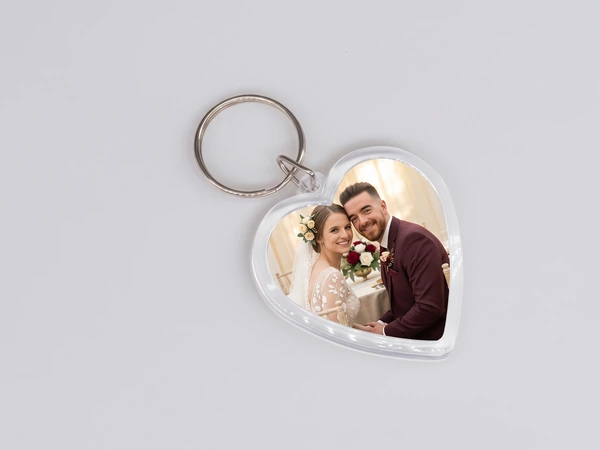 Heart keychain with a photo of a bride and a groom in a burgundy suit