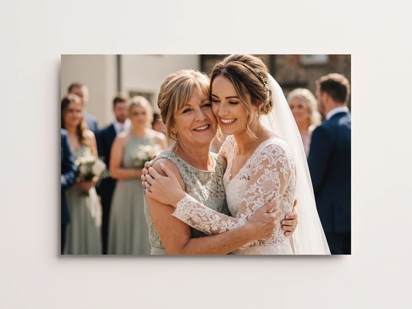 Metal print of a bride hugging her mother among wedding guests