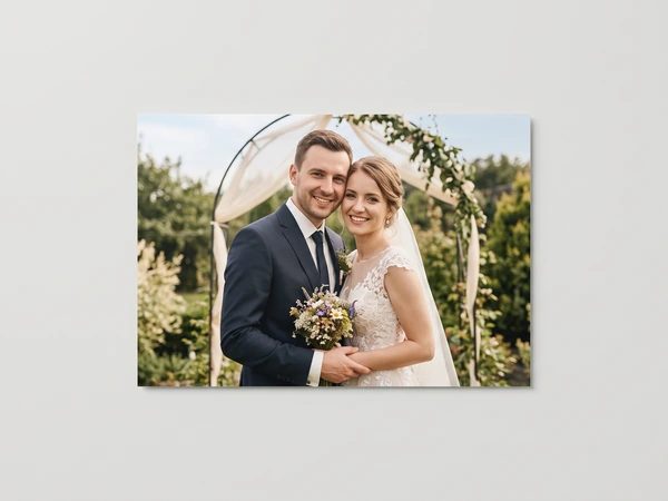 Metal print of a couple in front of a garden arbor with a small bouquet
