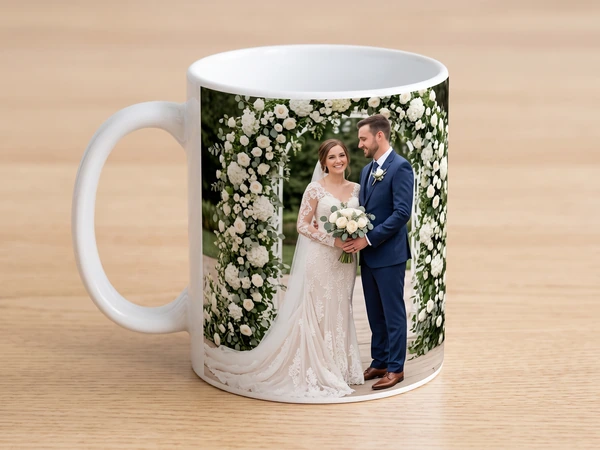 Photo mug printed with a bride and groom standing under a white rose arch