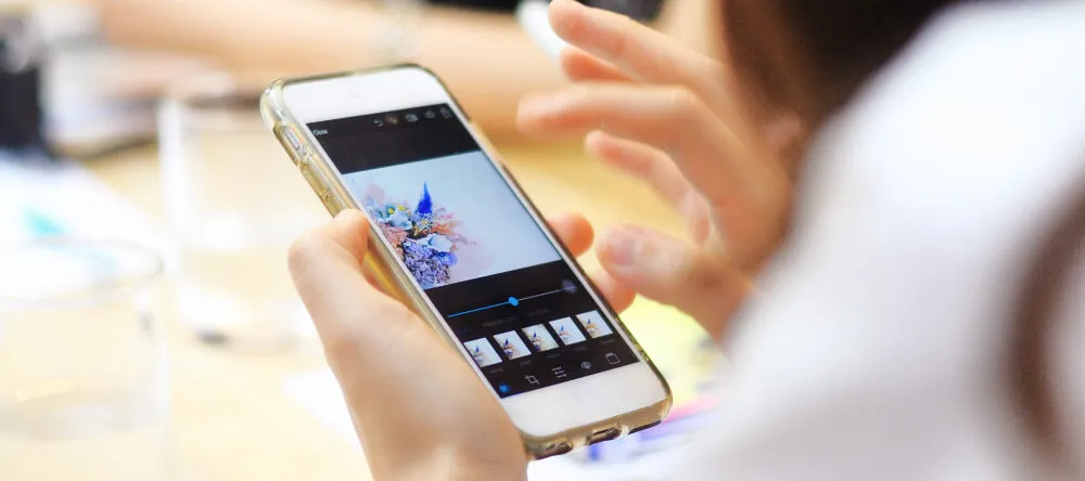 How to Edit Photos for Printing. Person looking at photos on their phone.