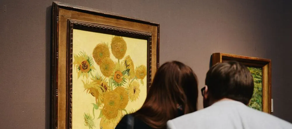 What is a Floating Frame for Canvas? Man and woman looking at framed painting.
