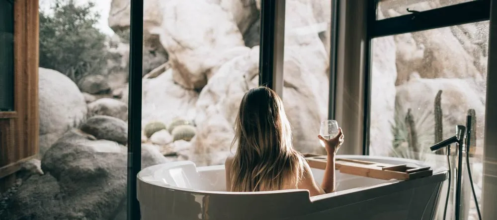 Bathroom Canvas Artwork. Woman in bath holding glass.